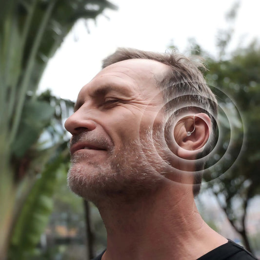 Discreet RIC hearing aid worn behind the ear by an adult for outdoor daily use
